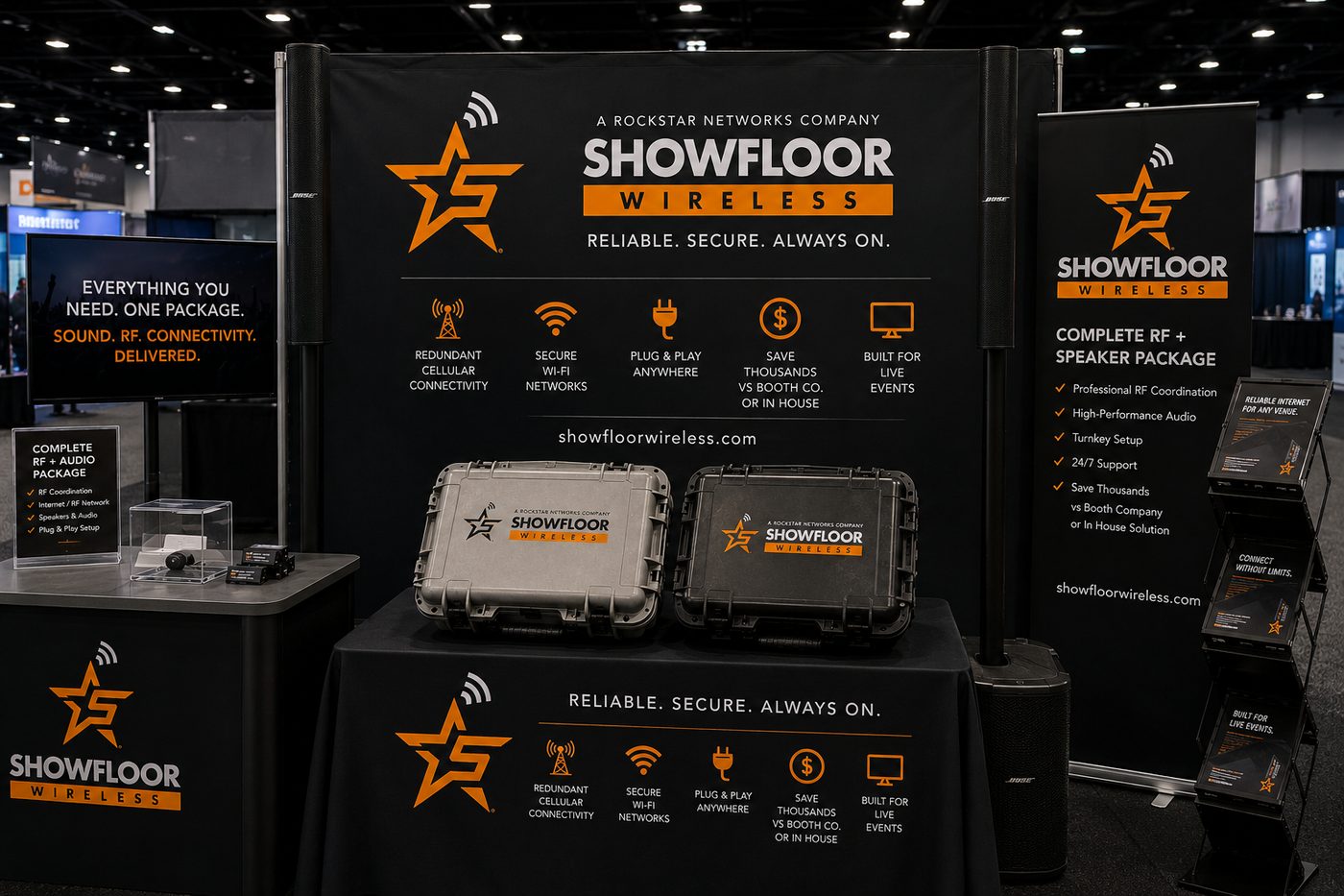 A trade show booth with two Bose speaker towers flanking the back wall